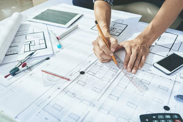 depositphotos_135582832-stock-photo-engineer-drawing-blueprint-of-building